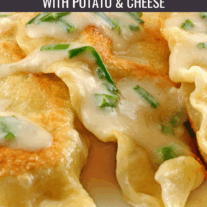 Homemade traditional pierogi filled with potato and cheese, topped with sour cream and chives.