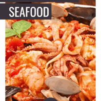 A serving platter of linguine with red sauce and mixed seafood; clams, squid, shrimp, scallops, and mussels.