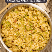 A pan filled with orecchiette pasta, Brussels sprouts and bacon.