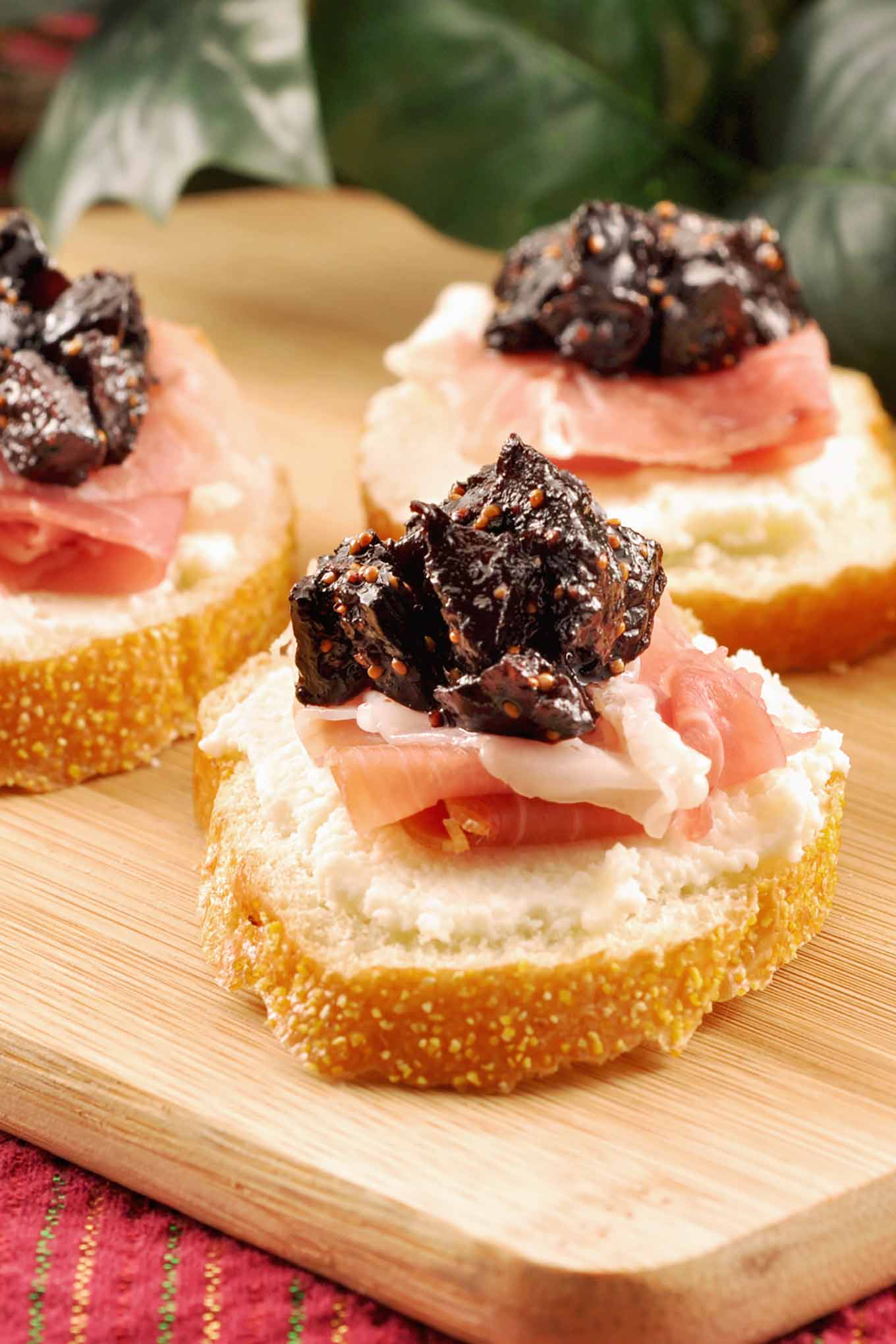 Crostini topped with whipped ricotta, prosciutto, and port wine fig compote.