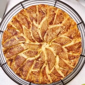 Apple coffee cake on a round cooling rack.