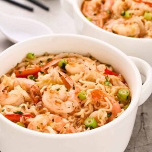 One-dish seafood dinner recipes; a bowl of spicy shrimp ramen soup with a second bowl in the background.