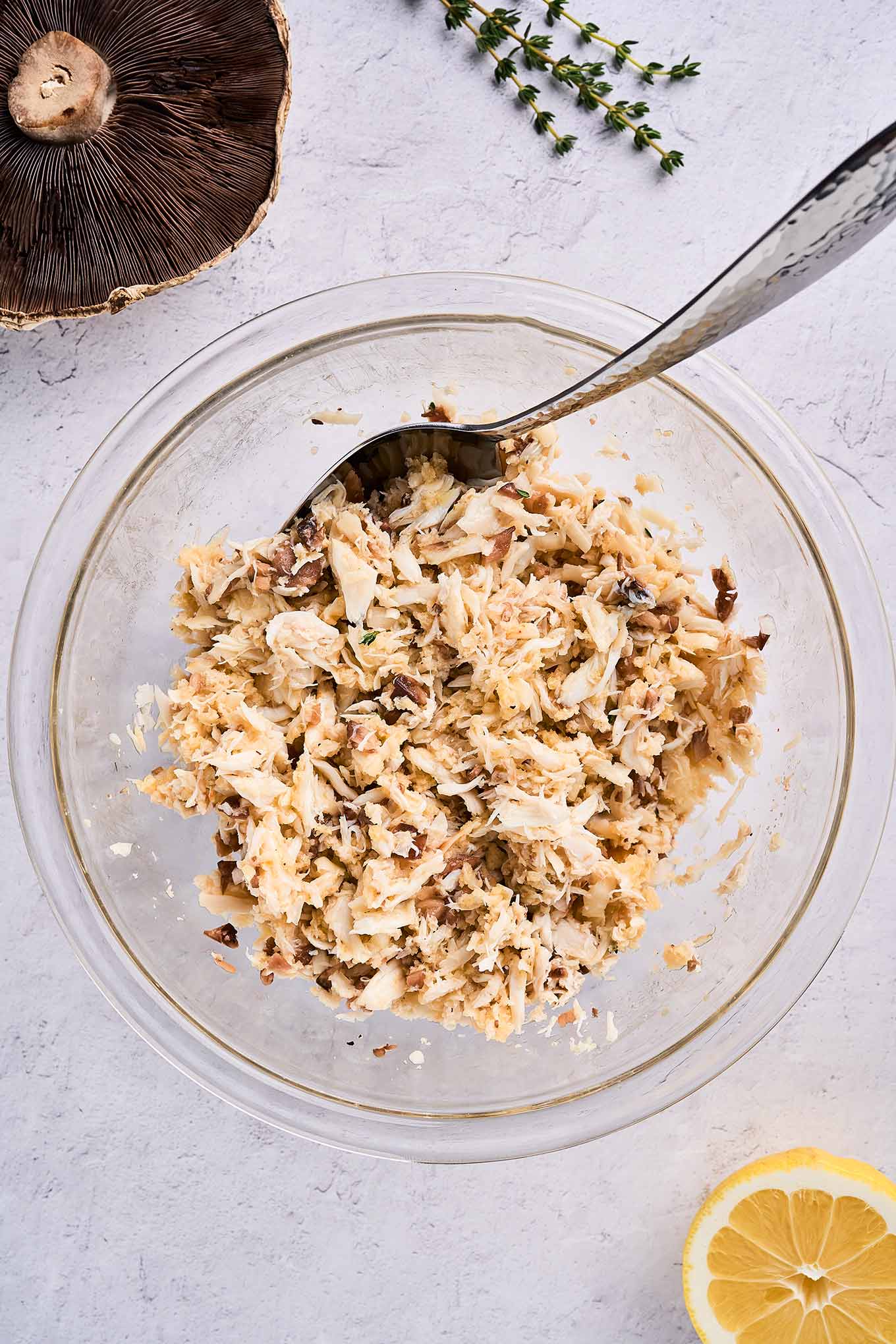 A mixing bowl of crab stuffing for portobello mushrooms, ready to be seasoned and added to the portobello mushroom caps.
