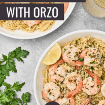 Shrimp scampi with orzo pasta served in white bowls, garnished with parsley and lemon wedges.