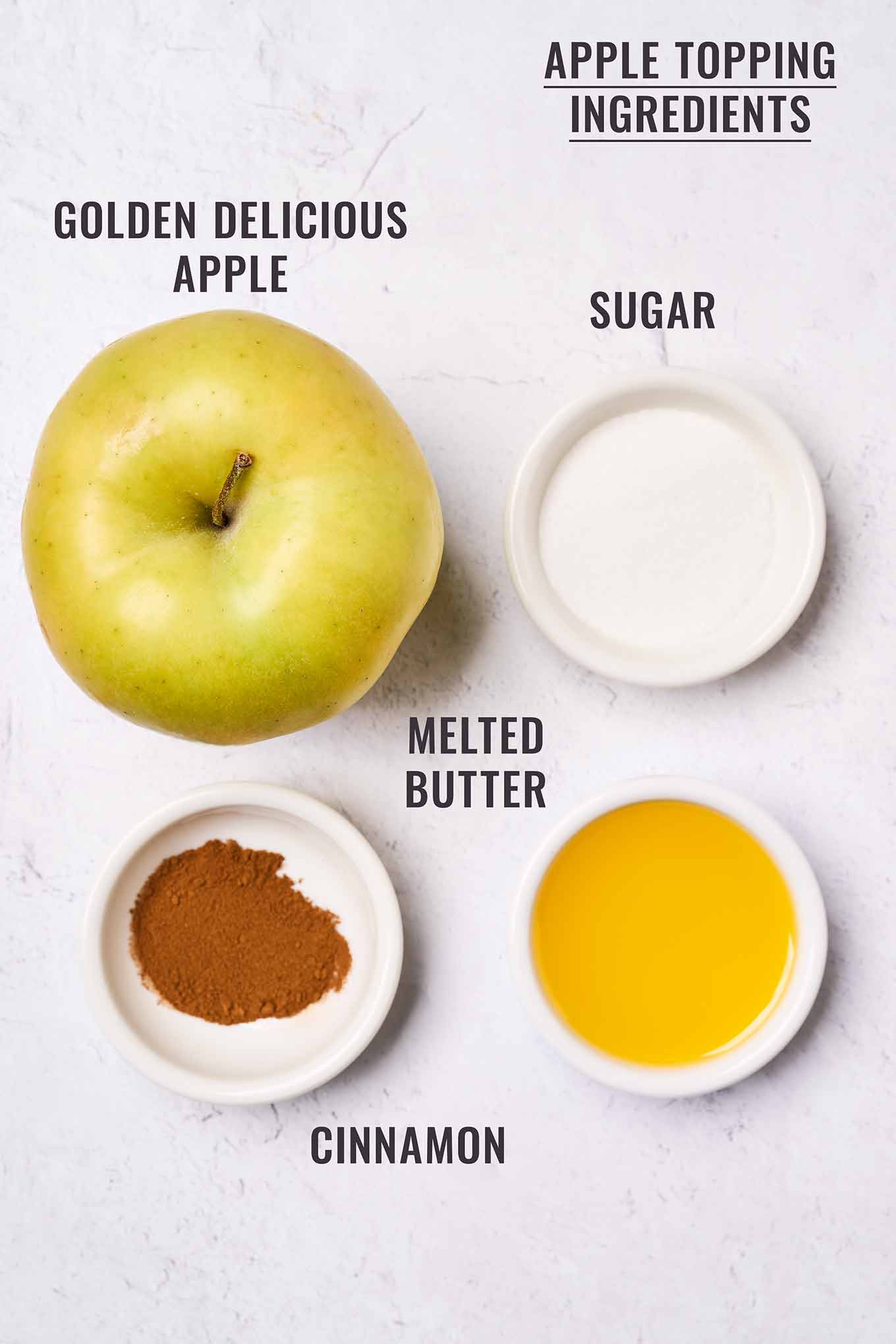 A labeled, overhead view of the topping ingredients for Golden Delicious apple cake; apple, melted butter, sugar, and cinnamon.