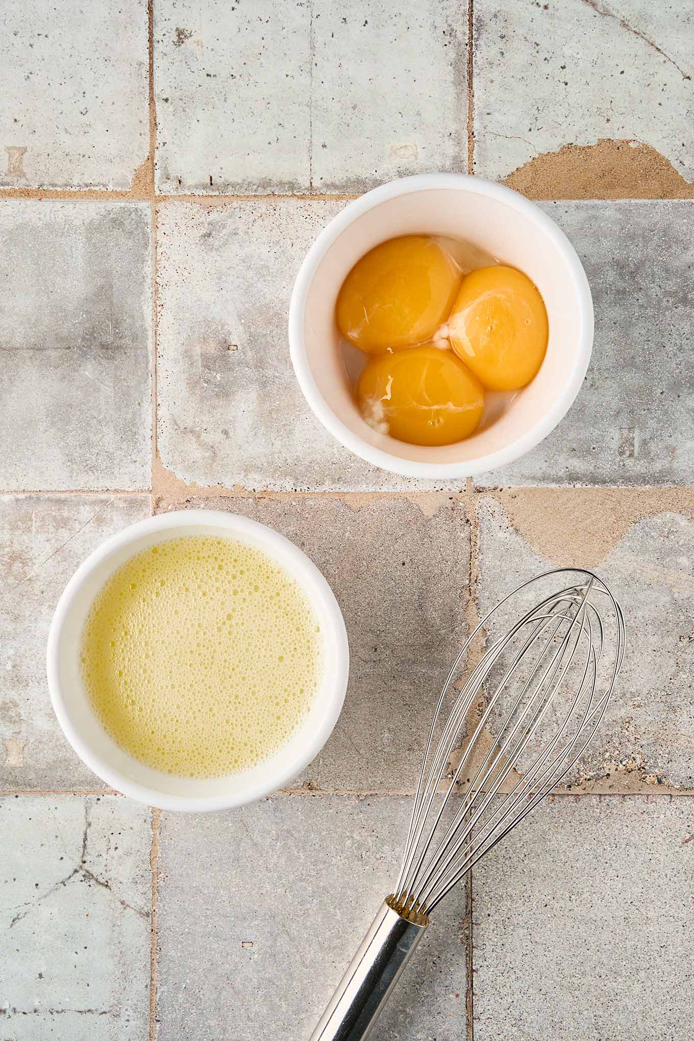 Frothy, whisked egg whites ready to be combined with the yolks before tempering to thicken egg and lemon soup.