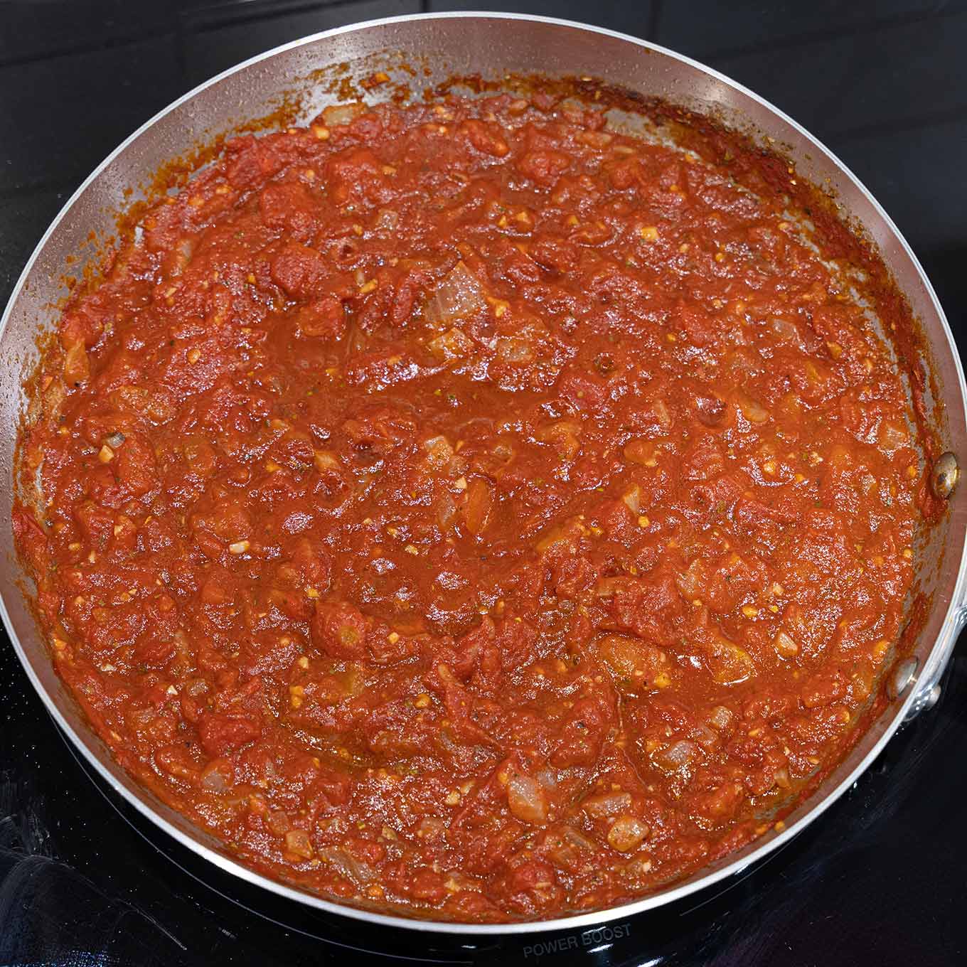 Homemade marinara sauce with garlic, onion, and Italian tomatoes for sausage lasagna.