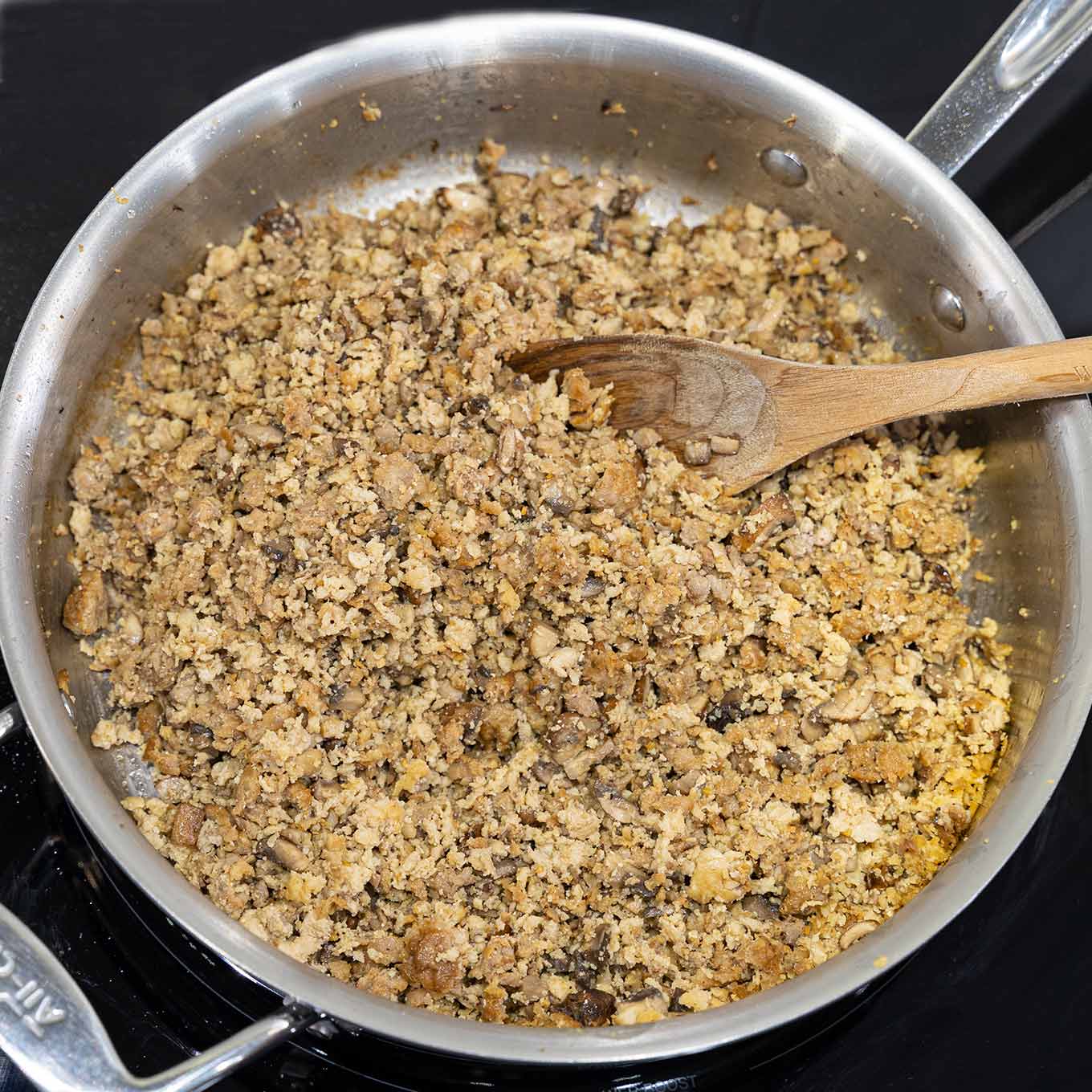Finely crumbled Italian sausage and ground meat, browned with chopped mushrooms, onions, and garlic for the meat filling for sausage lasagna.