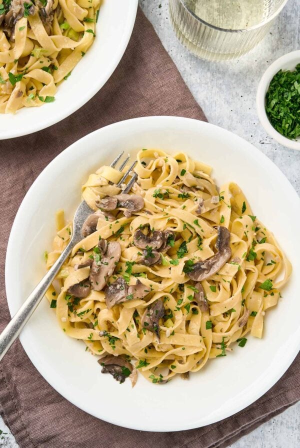 Creamy truffle mushroom pasta with fettuccine, sautéed mushrooms, and chopped parsley.