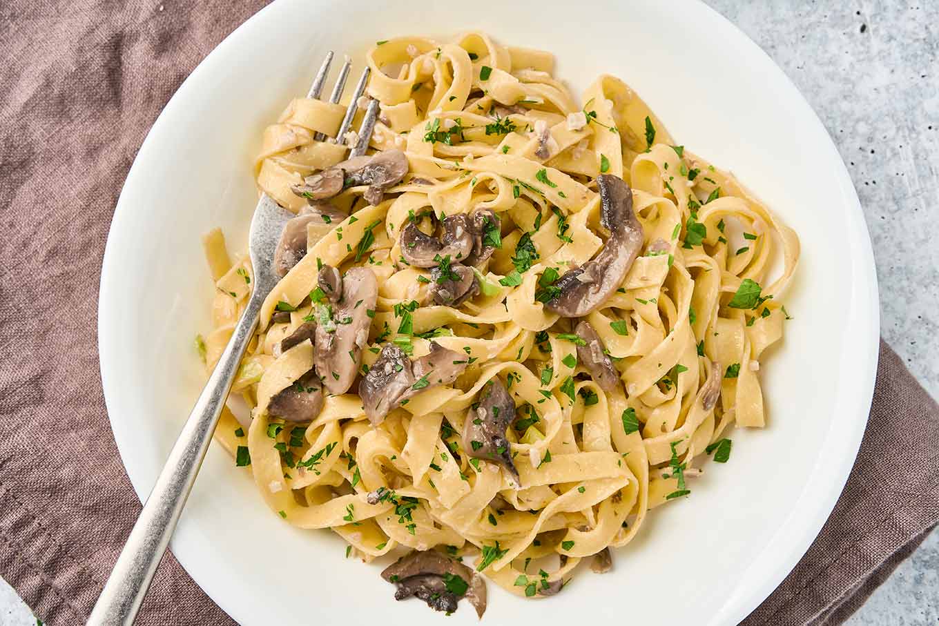 Fettuccine pasta tossed with saut&eacute;d mushrooms and fresh parsley in a creamy truffle sauce.