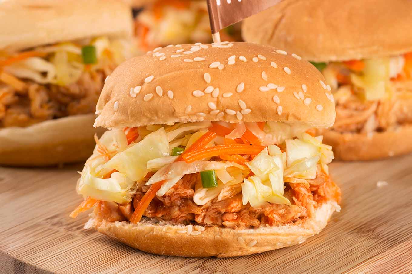 Instant Pot pulled BBQ chicken on sesame slider buns with coleslaw.