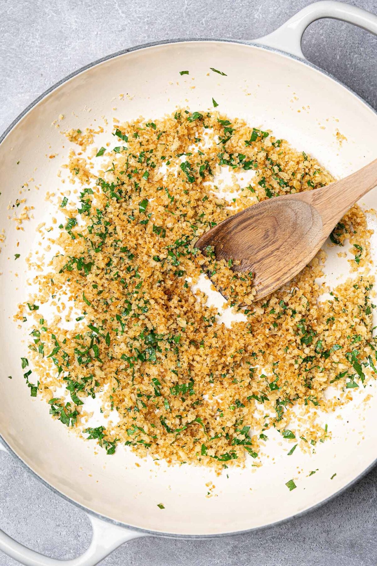 Toasted panko breadcrumbs with garlic, onion, pine nuts, and parsley in a skillet, stirred until golden.