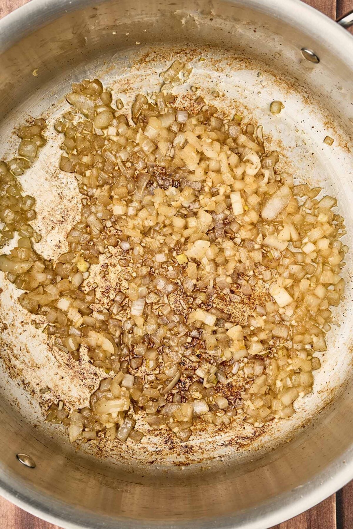 Diced onion and garlic saut&eacute;ing in bacon drippings and olive oil for fire-roasted tomato and bacon soup.