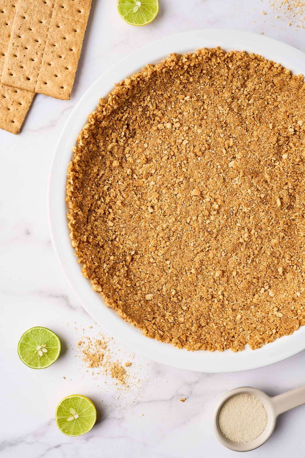 Graham cracker crust pressed into pie plate for Florida Key lime pie, ready to bake.