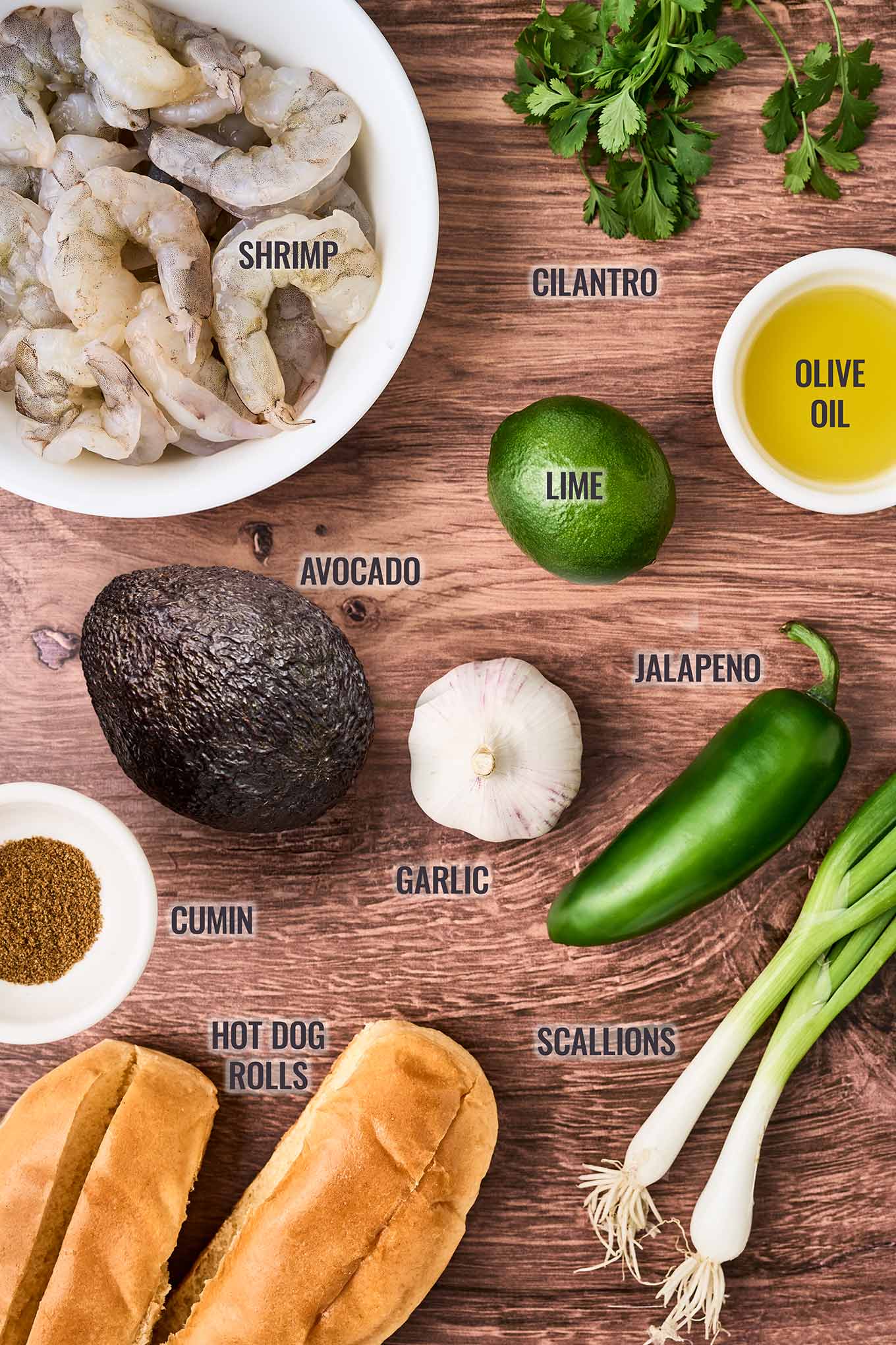 Ingredients for shrimp rolls with avocado mayonnaise; extra-large shrimp, avocado, mayo, cilantro, lime, olive oil, garlic, jalapeno, scallions, cumin, and rolls.