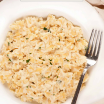 Cottage cheese macaroni and cheese with fontina in a serving bowl with a fork.