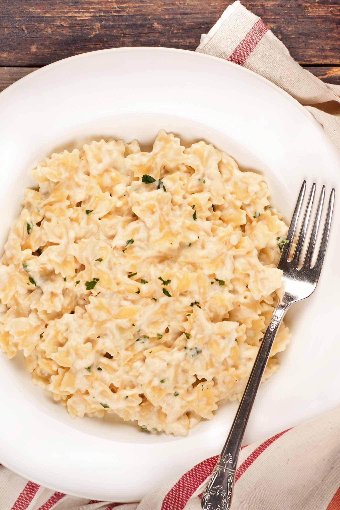A single serving of cottage cheese mac and cheese with fontina in a white bowl.