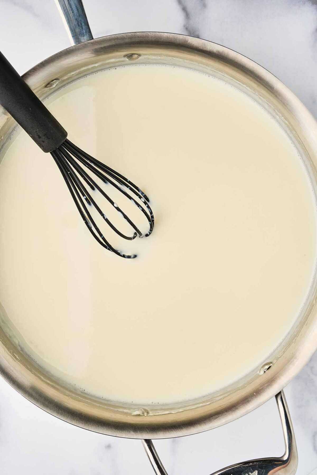 Warm milk whisked into b&eacute;chamel sauce for French macaroni and cheese.