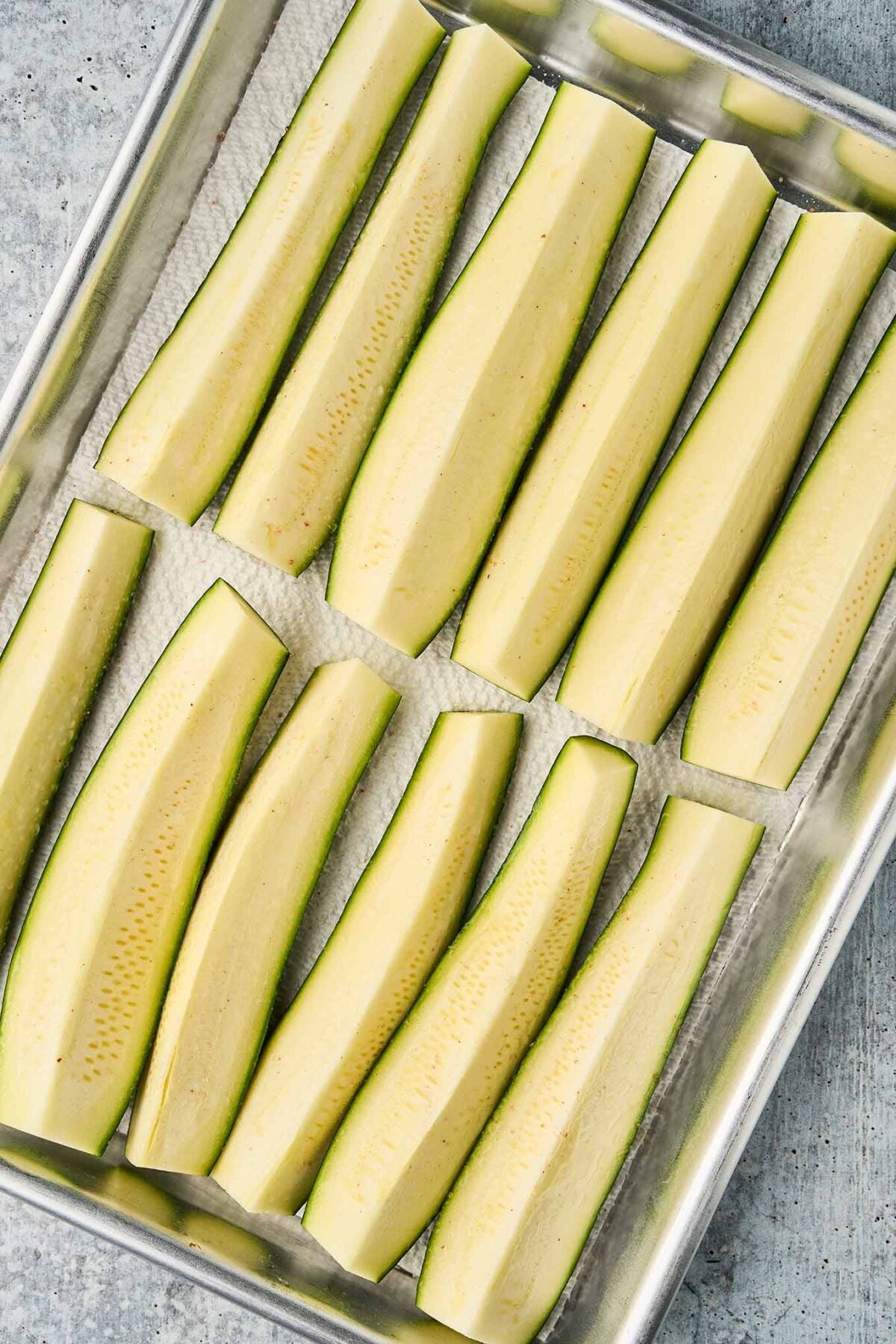 Fresh zucchini, quartered and salted to draw out moisture before being diced for shrimp and zucchini pasta.