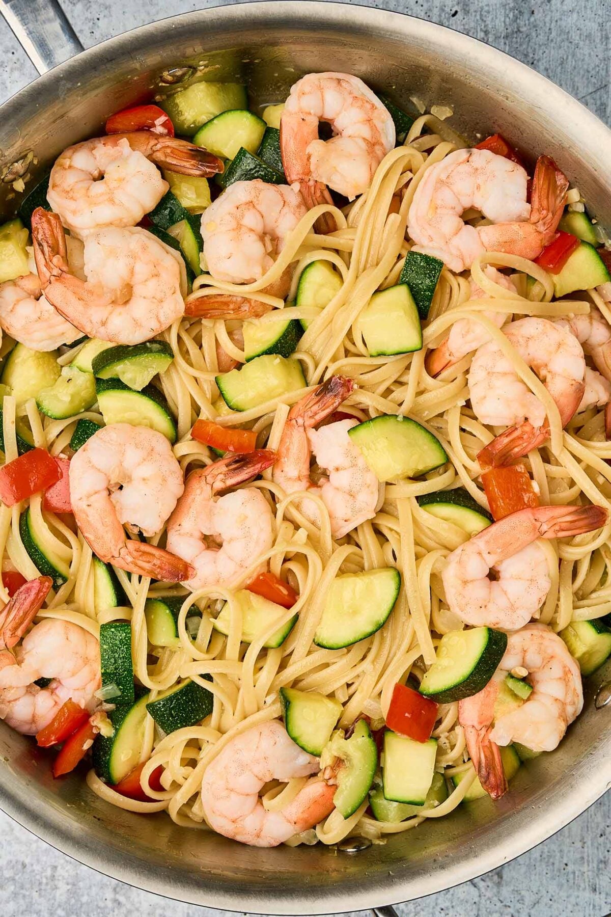 Linguine tossed with shrimp and sautéed vegetables for shrimp and zucchini pasta.