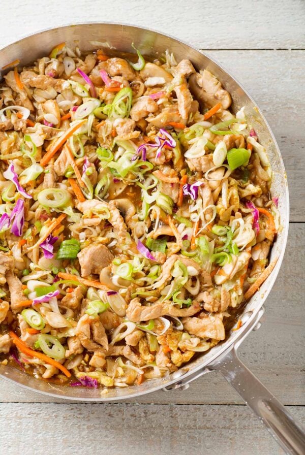 Moo shu pork stir-fry with sliced pork, cabbage, mushrooms, carrots, eggs, and scallions.