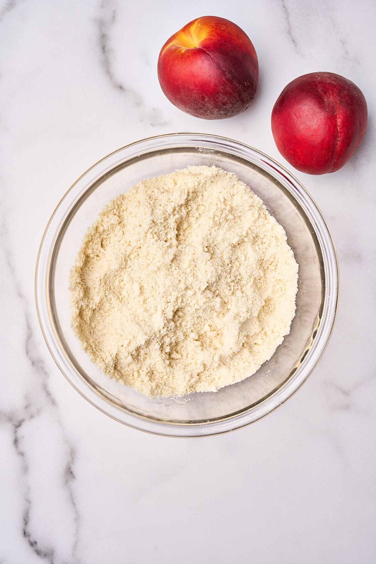 Cold butter worked into the dry ingredients for fresh peach cobbler biscuit topping.
