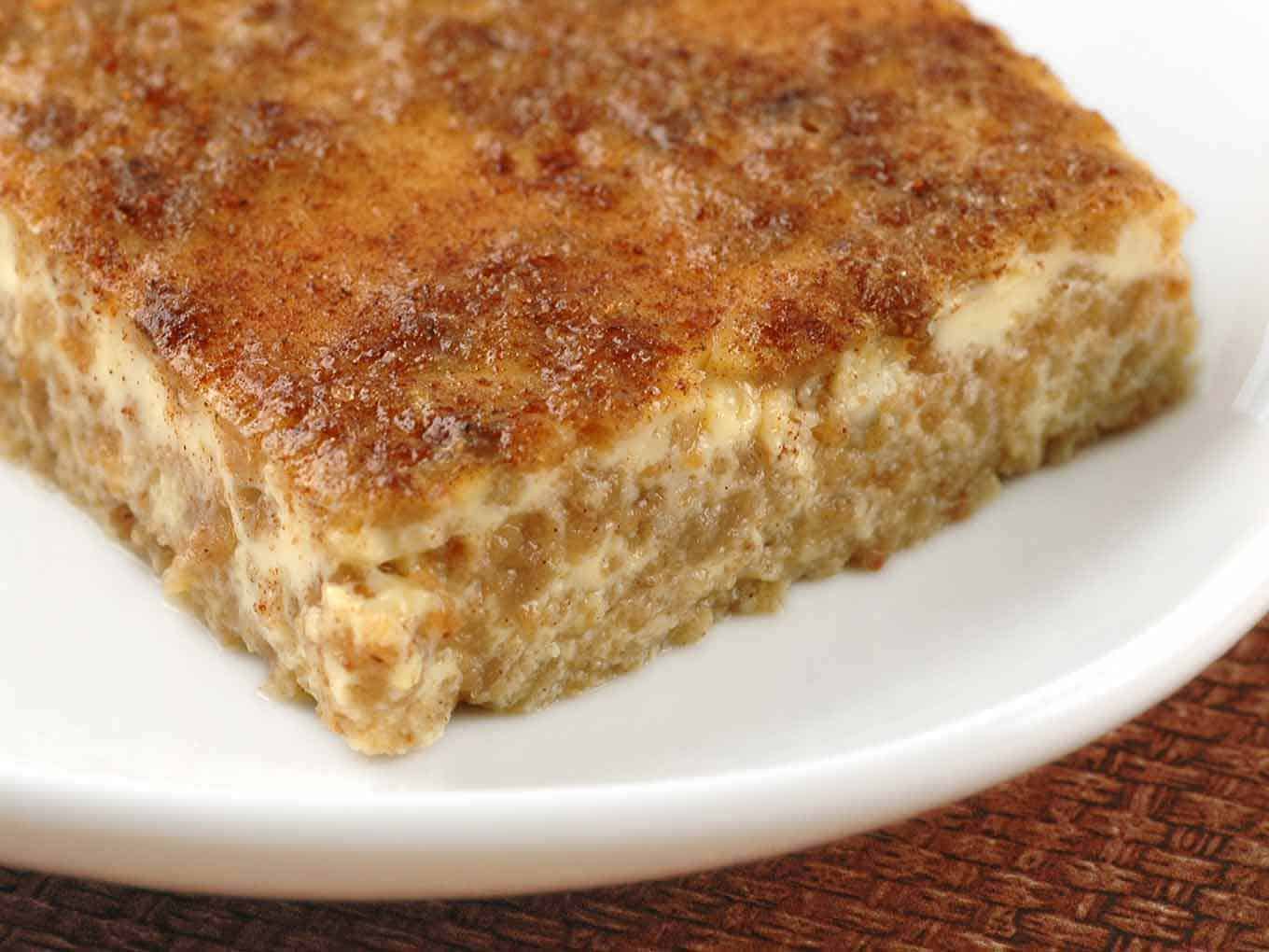 A thin slice of Grape Nut pudding showing the cereal distributed throughout the custard.