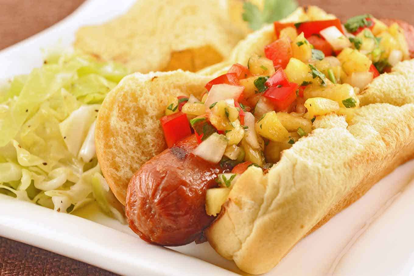 https://www.mygourmetconnection.com/wp-content/uploads/grilled-hot-dogs-pineapple-pepper-relish.jpg