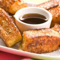 Single serving of Hawaiian French toast sticks with maple syrup.