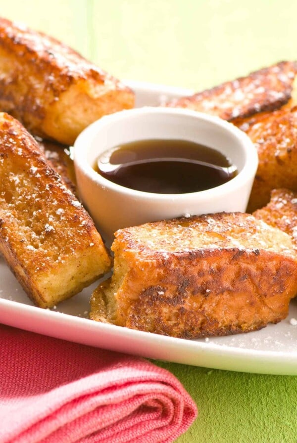 Single serving of Hawaiian French toast sticks with maple syrup.