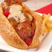 Toasted sesame seed sub roll filled with meatballs, sautéed mushrooms, bell peppers, marinara sauce, and melted cheese, served with seasoned French fries.